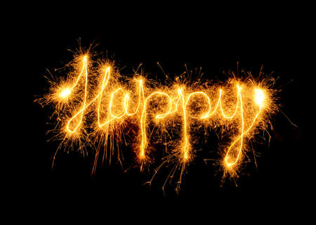 Inscription Happy from sparks. It is isolated on a black backgroundの写真素材
