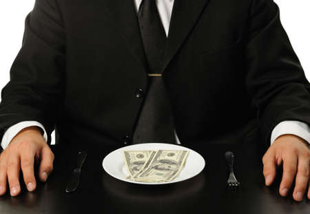 The businessman having dinner dollars. Fun on a theme of the financeの写真素材