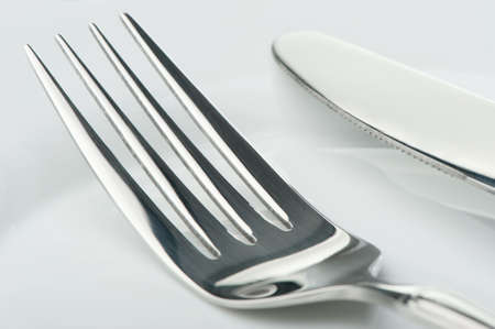 Knife and fork on a plate. Kitchen accessories close upの写真素材