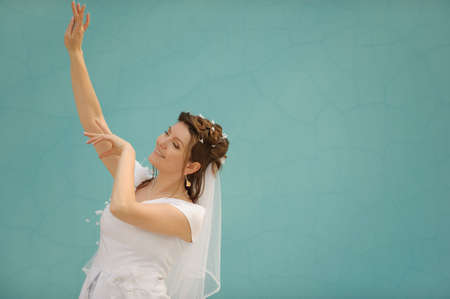 The dancing bride. The young girl in a wedding dress on an abstract background. East danceの写真素材