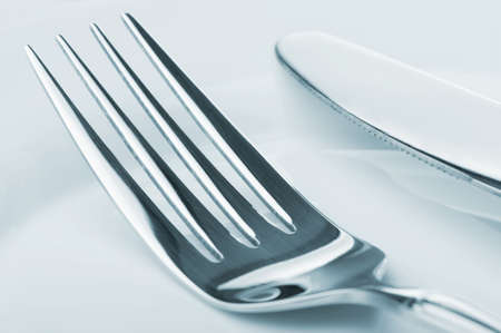 Knife and fork on a plate. Kitchen accessories close upの写真素材