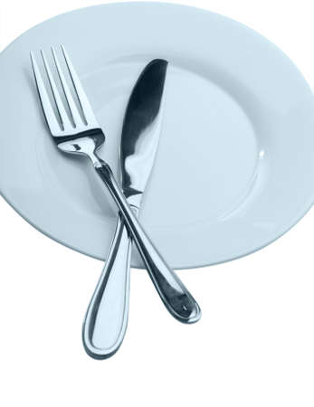 Knife and fork on a plate. Kitchen accessories close upの写真素材