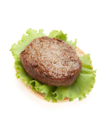 Cutlets with a leaf of salad on on bread. It is isolated on a white backgroundの写真素材