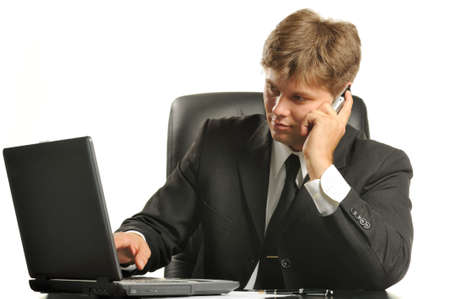 The young businessman on a workplace. It is isolated on a white backgroundの写真素材
