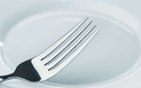fork on a plate. Kitchen accessories close upの写真素材