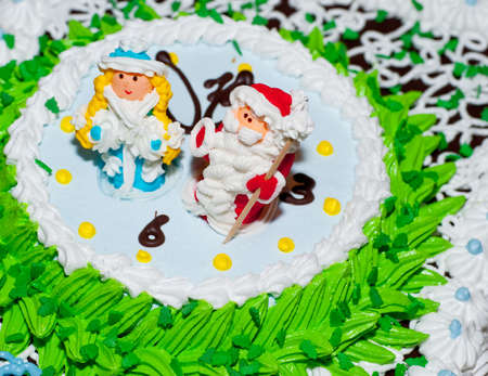 New Year's cake. Decorated the Snow Maiden and Santa on hours.の写真素材