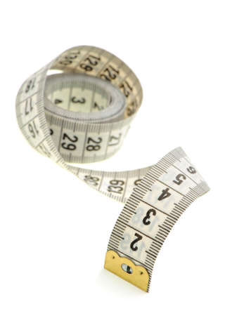 Measuring tape of the tailor white color. It is isolated on a white backgroundの写真素材