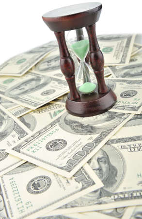 Sand-glass on dollars blue tone. Concept time - moneyの写真素材