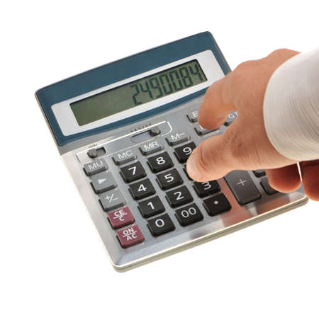 The calculator and a hand of the man. Pressing of a key of the calculatorの写真素材