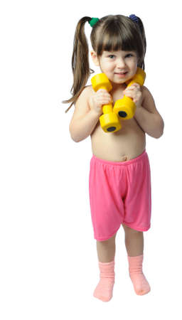 The little girl with dumbbells. It is isolated on a white backgroundの写真素材