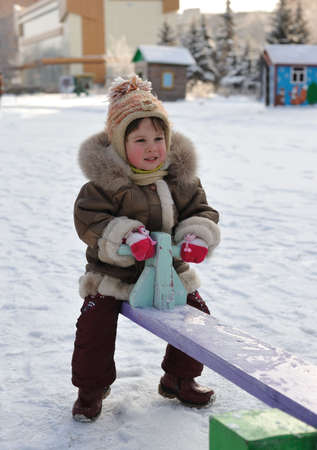The girl on a swing. Winter, solar frosty weatherの写真素材