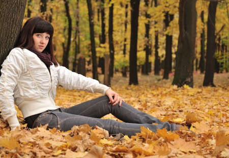 The girl in an autumn forest. The European appearanceの写真素材