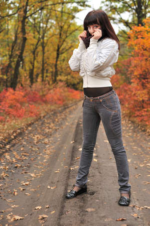 The girl in an autumn forest. The European appearanceの写真素材