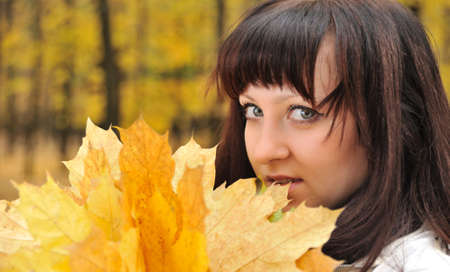 The girl in an autumn forest. The European appearanceの写真素材
