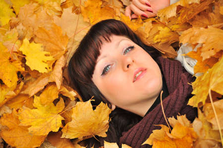 The girl in autumn leaves. The European appearanceの写真素材