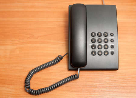 Phone on a table. device for conveying sounds over great distances by changing the sounds into...