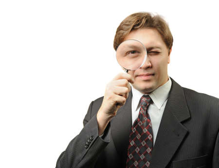 The man with a magnifier. It is isolated on a white backgroundの写真素材