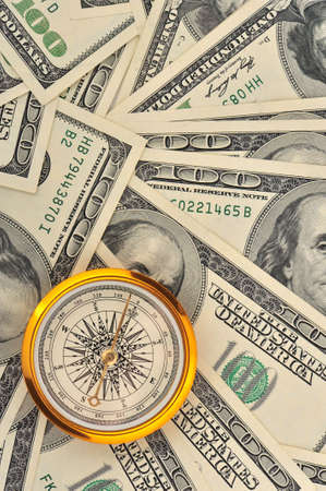 Dollars and compass. Concept about a direction in businessの写真素材