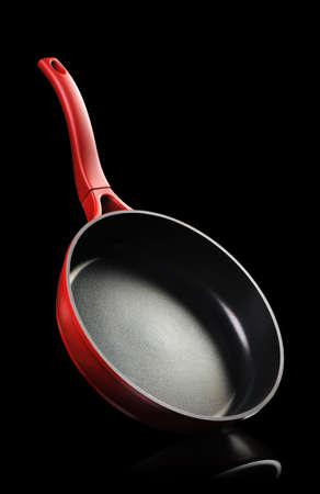 Frying pan - kitchen utensils It is isolated on a blsck backgroundの写真素材