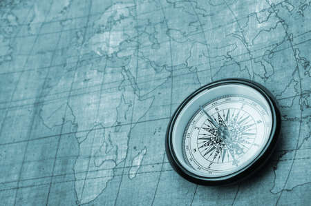 Compass on old map. Blue tone background