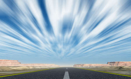 Asphalt road. A transport highway with with motion cloudsの写真素材