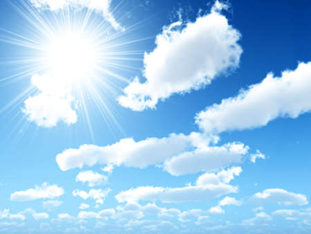 Bright beams of the sun in the blue sky with fluffy clouds