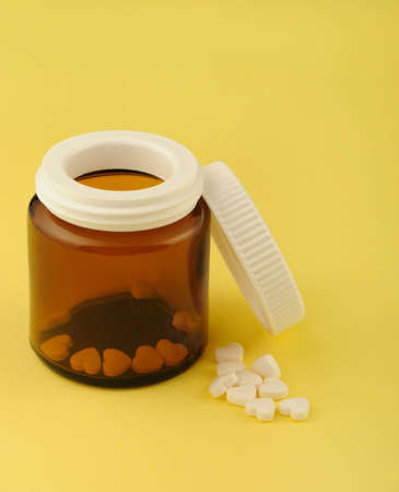 Tablets in the form of heart. Tablets from intimately vascular diseases with glass opened cupping-glassの写真素材