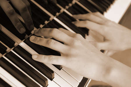 Hands above keys of the pianoの写真素材