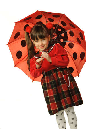 The little girl with a umbrella. It is isolated on a white backgroundの写真素材