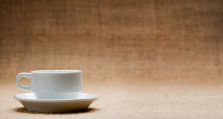 White cup on grunge a background. Old toneの写真素材