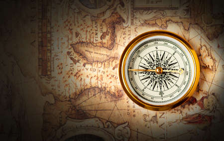 Old compass on ancient map. A compass with the antique image of a directionの写真素材