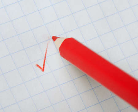 Red pencil writing a mark. Abstract conceptの写真素材