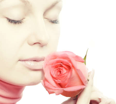 The woman with a rose. A warm tonality. Isolated on whiteの写真素材