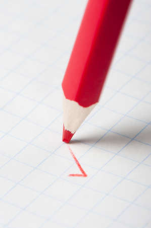 Red pencil writing a mark. Abstract conceptの写真素材