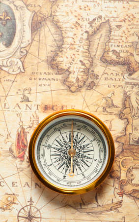 Old compass on ancient map. A compass with the antique image of a directionの写真素材