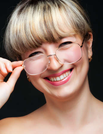 Portrait of the woman in eyeglasses close up. The bared shoulders.の写真素材