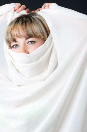 The woman close up. Face partially covered pareo.