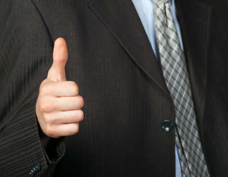 A photo of a hand doing a thumb up gesture. Focus on thumbの写真素材