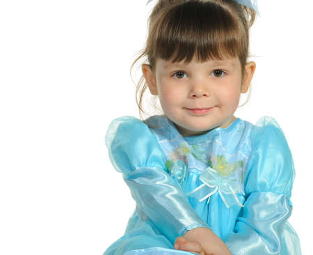 Pretty the little girl in a blue dress. It is isolated on a white backgroundの写真素材
