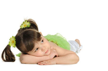 Pretty the little girl lies on the white. It is isolated on a white backgroundの写真素材
