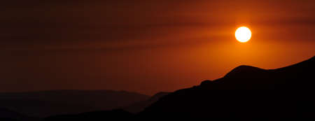 Colourful decline over mountains. Red colourの写真素材