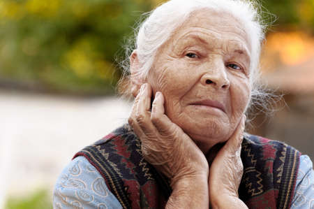 Portrait of the elderly woman. A photo on outdoors