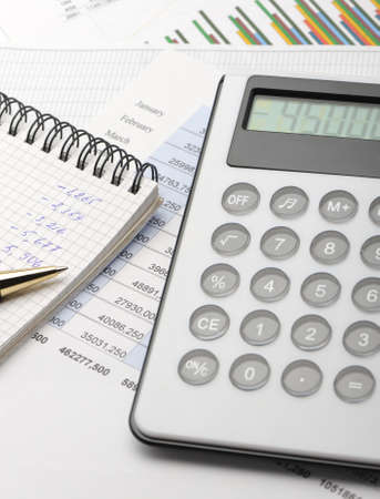 The calculator and the financial report. A workplace of the businessmanの写真素材