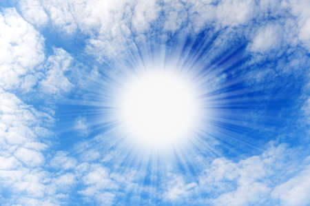 Shining sun with beams in the centre of clouds.Small wavy cloudsの写真素材