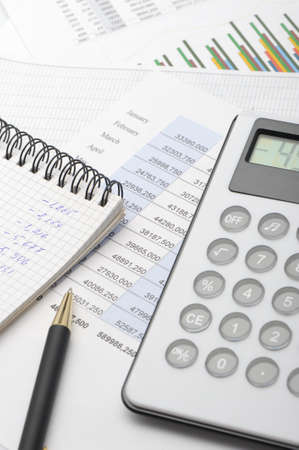 The calculator and the financial report. A workplace of the businessmanの写真素材