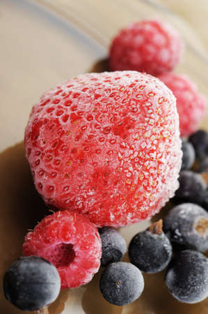 The frozen raspberry, strawberry, bilberry. Berries covered with hoarfrost.の写真素材
