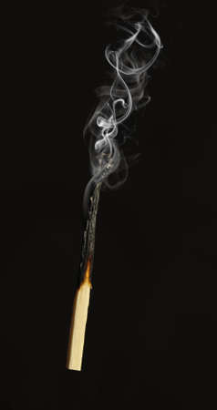 Extinct match. A photo close up, a dark backgroundの写真素材