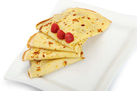 Crepe on a plate with a raspberry. A detailed photo fried thin pancake.Isolated on whiteの写真素材