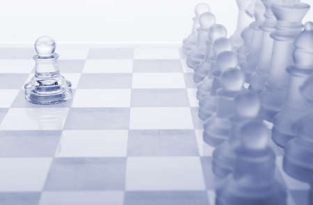 Glass chess. The first move. Blue toned.の写真素材
