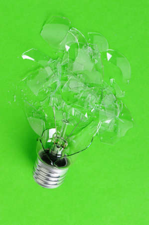The brokenbulb. Glass splinters on a green backgroundの写真素材